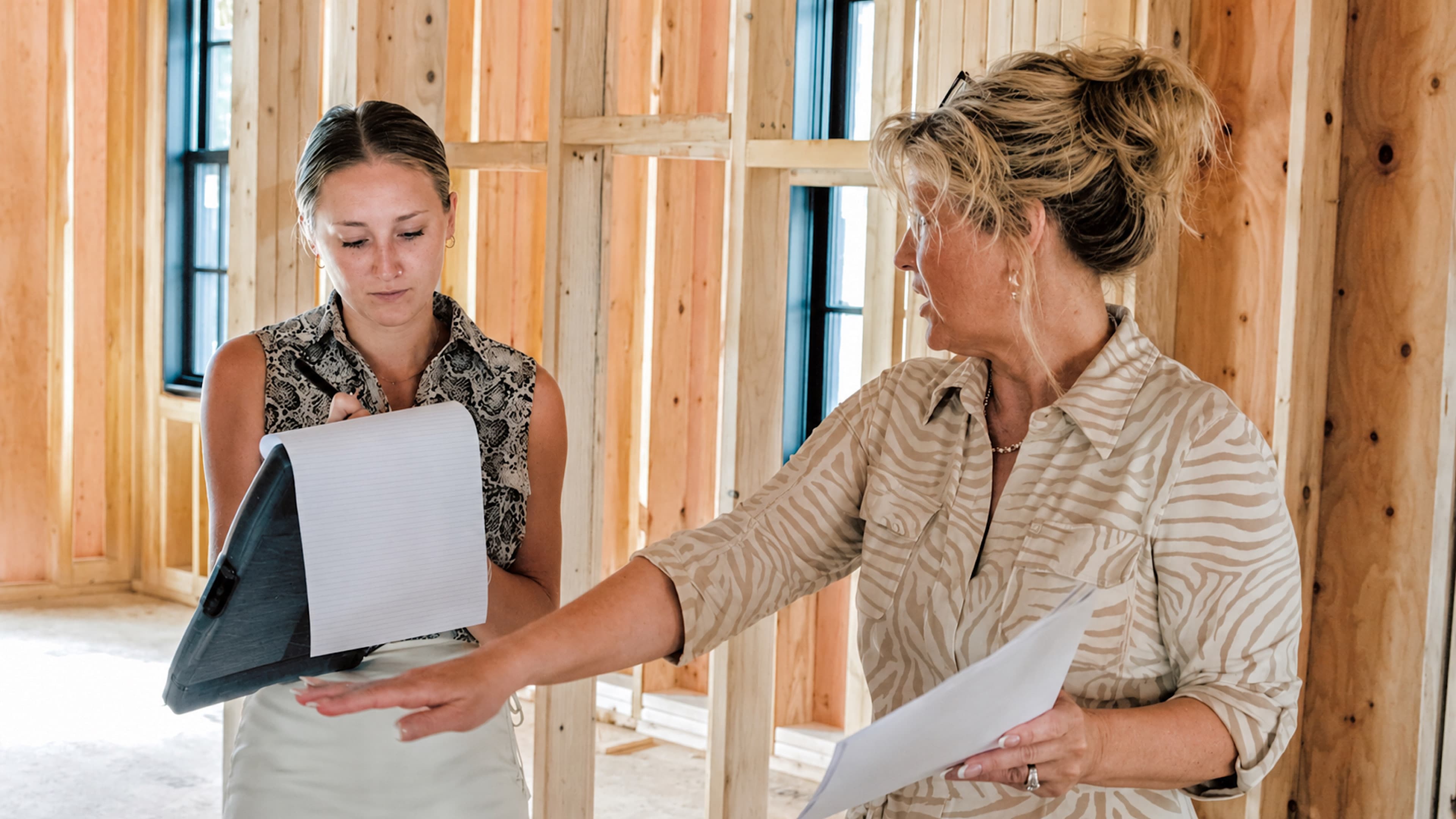 Longfellow project manager walking a client through field conditions on a framed second floor